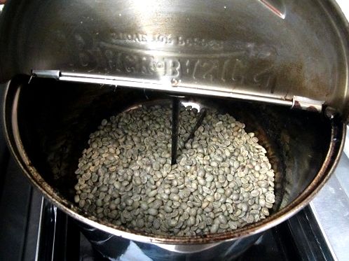 roasting green coffee beans in popcorn popper on grill 